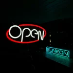 Open LED neon sign in red and white oval design for businesses